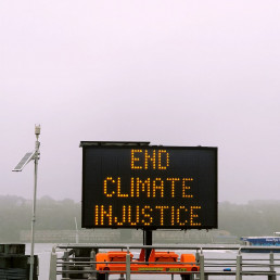 A sign that reads End Climate Injustice.